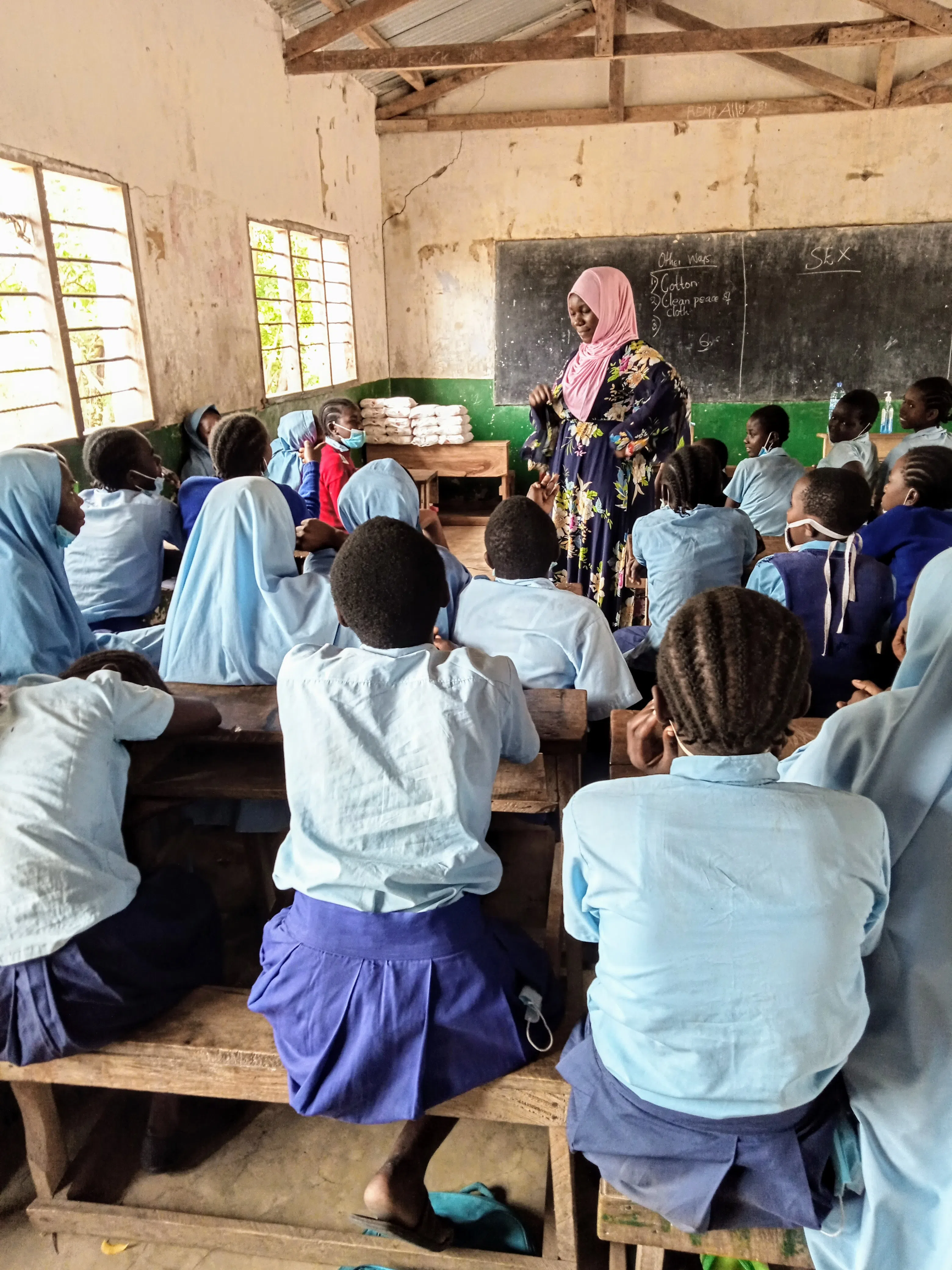 A group of Kenyan girls and their teacher in the classroom