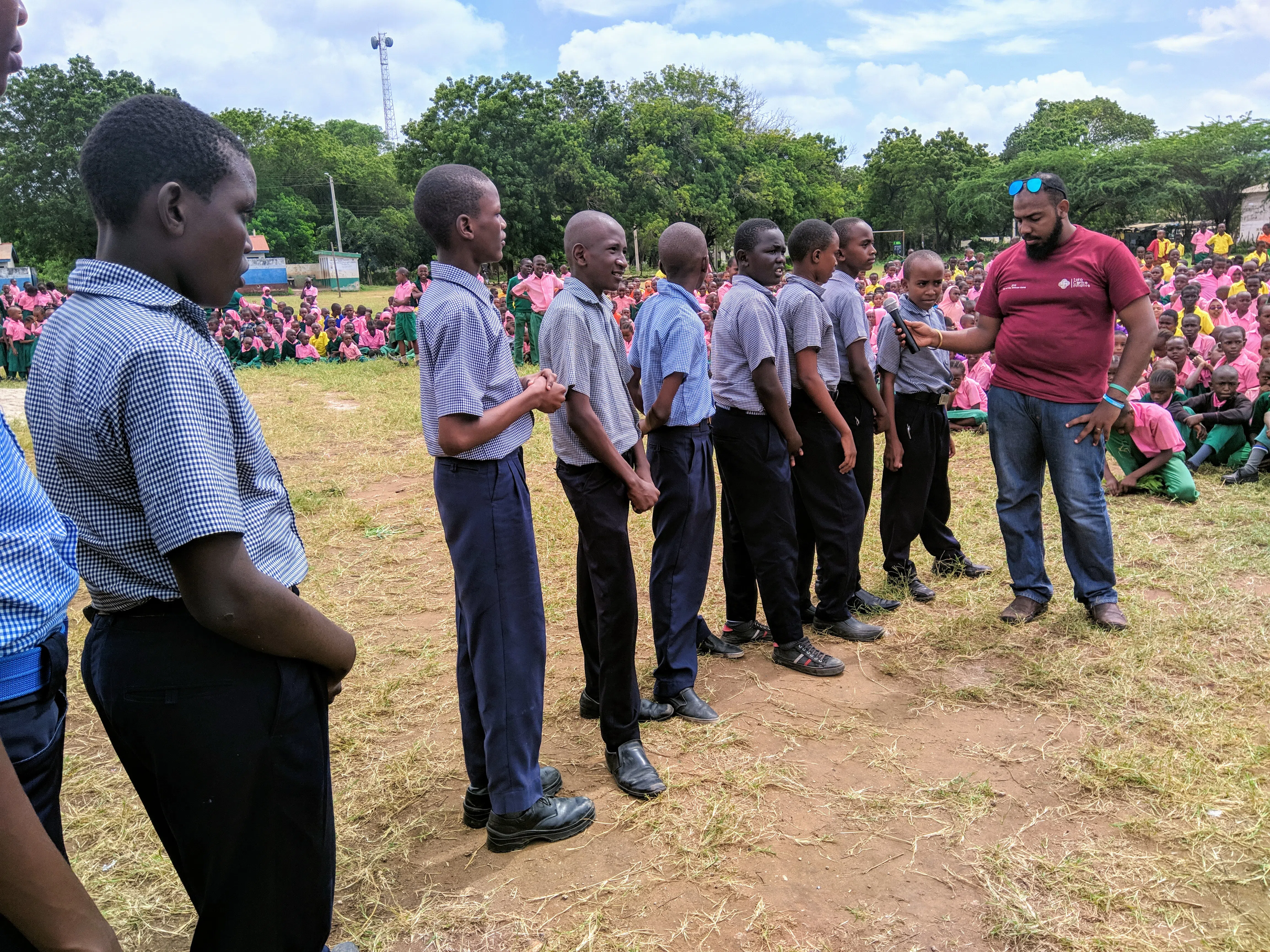 A group of boys and their teacher lining up for a commemoration