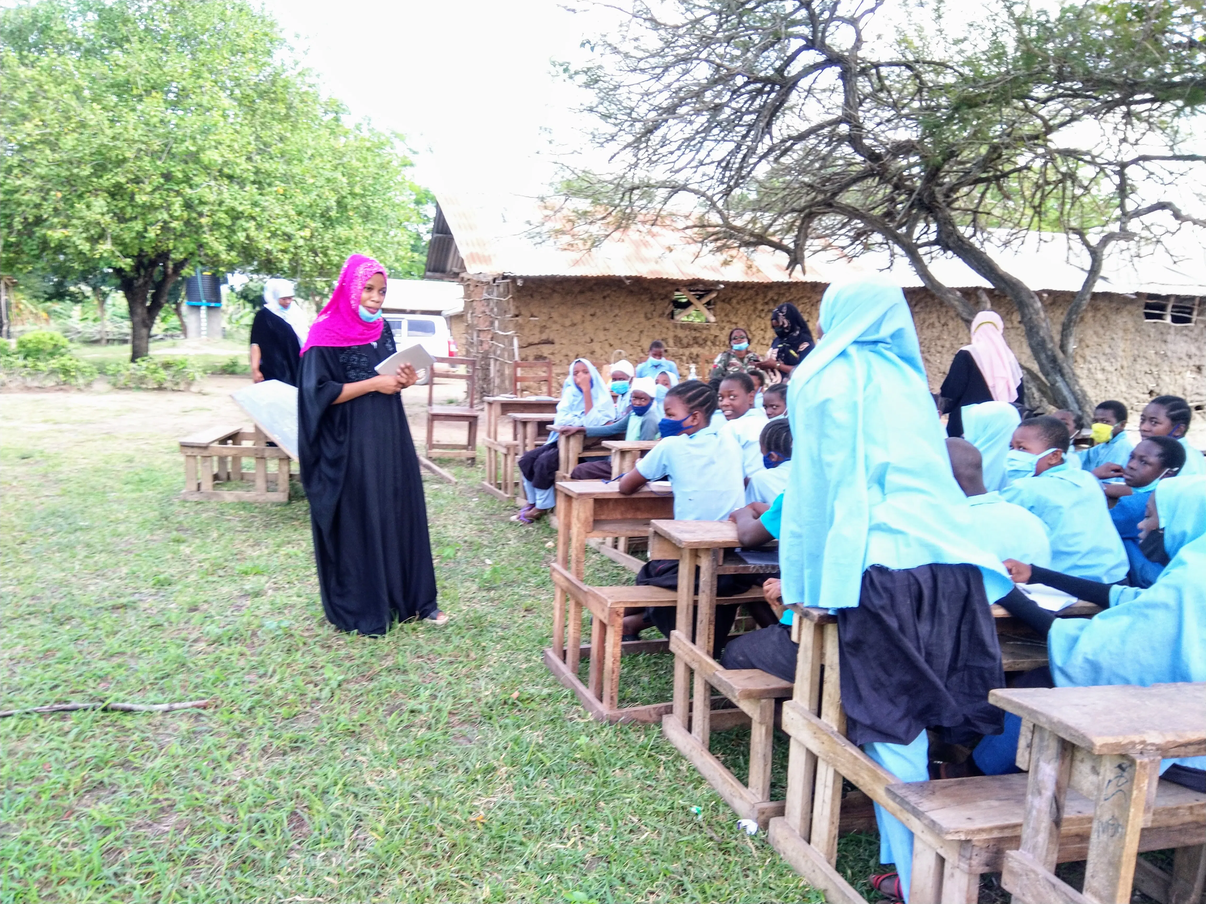A group of kenyan muslim girls learning life skills outside