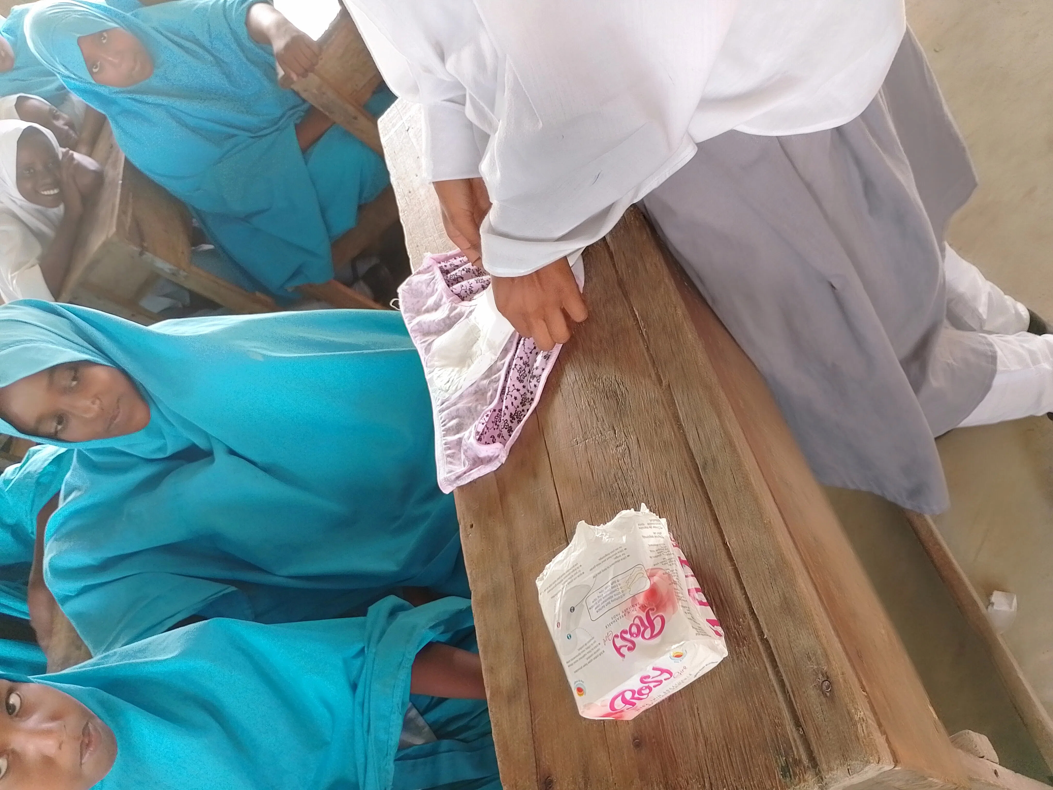 A girl showing other girls how to use a pad